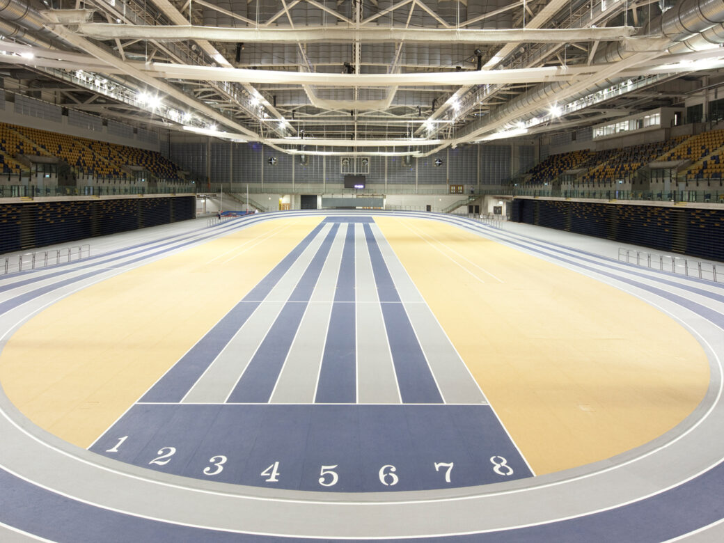 Indoor track hall in Glasgow International Arena, large beams visible